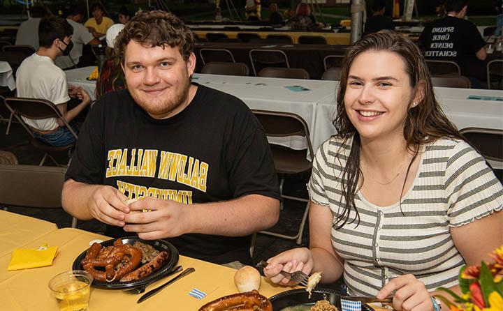Photo of Two Students Enjoying Food at BW German Club Oktoberfest 